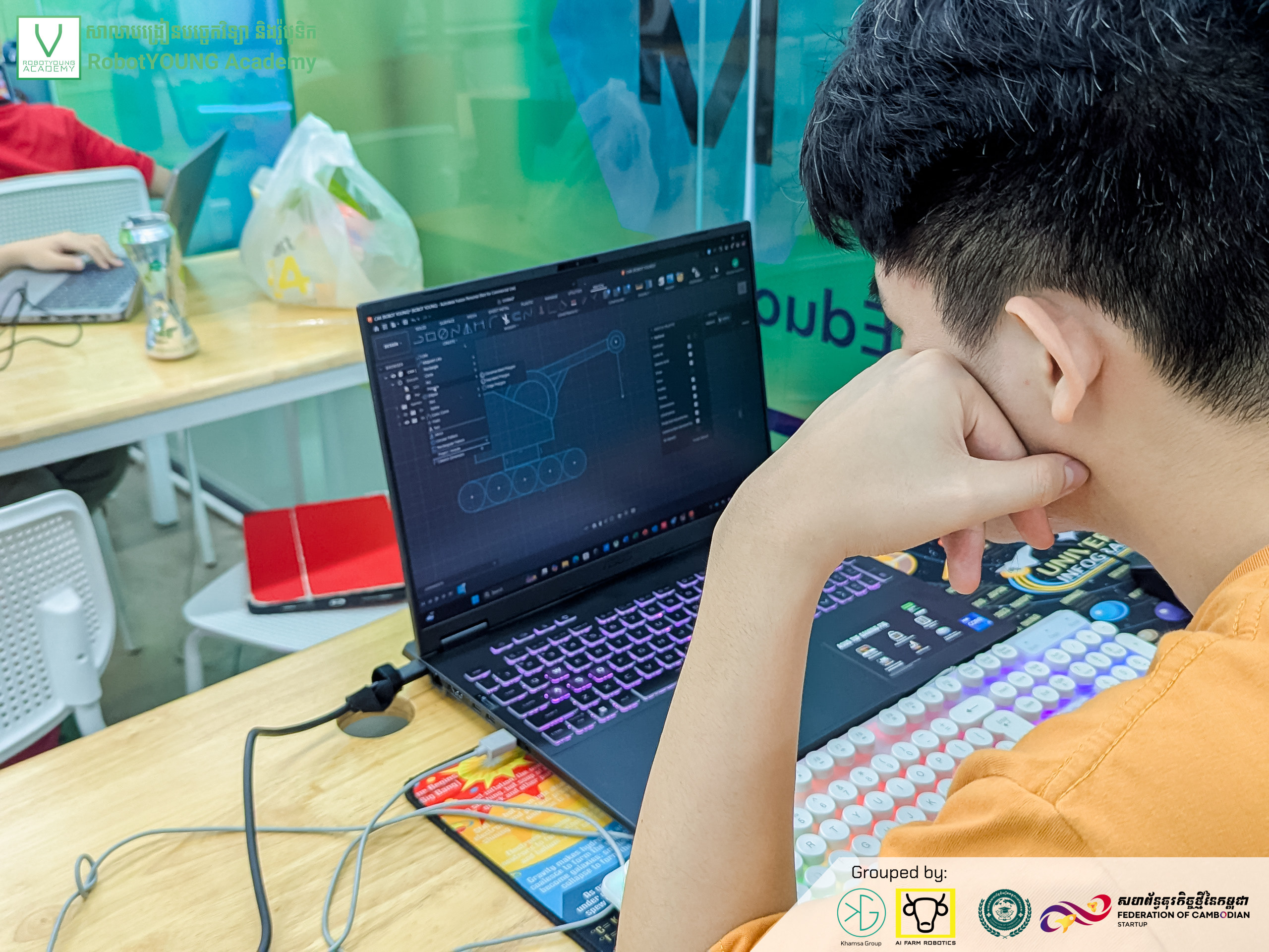 A student studying a block-based programming workspace on a laptop
